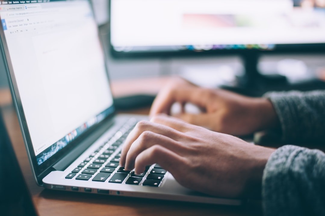 Person typing a message on a laptop