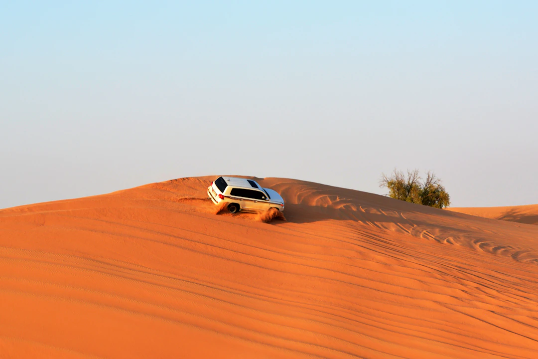 White SUV on a desert road in the UAE, representative of a family SUV